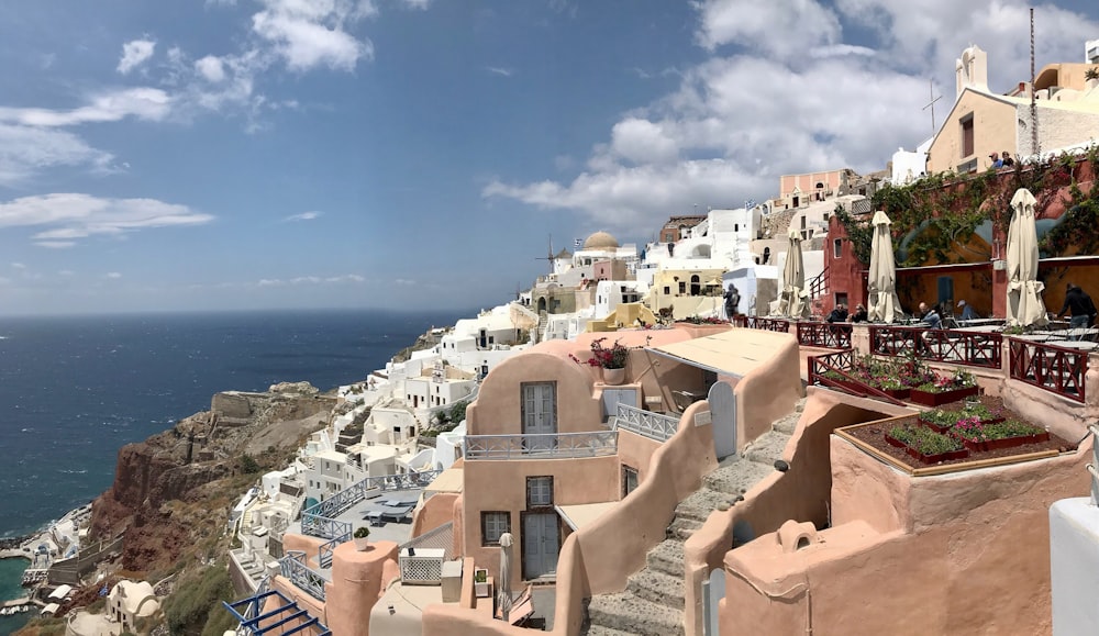 brown and white concrete houses near sea under blue sky during daytime