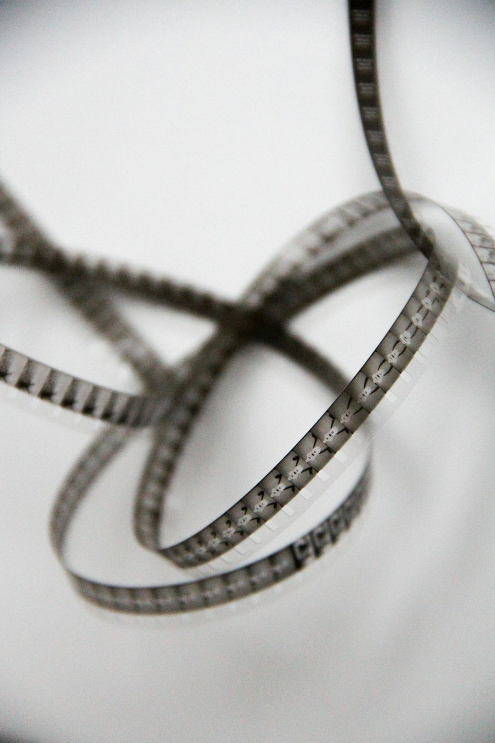 silver and diamond ring on white textile