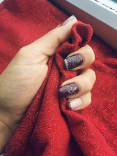 Bold gel manicure with bright red extensions styled in a sharp square shape