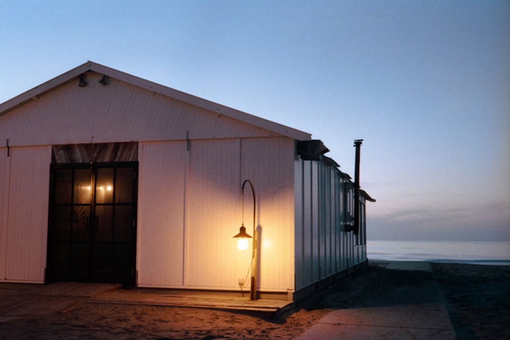 white wooden house near body of water during daytime