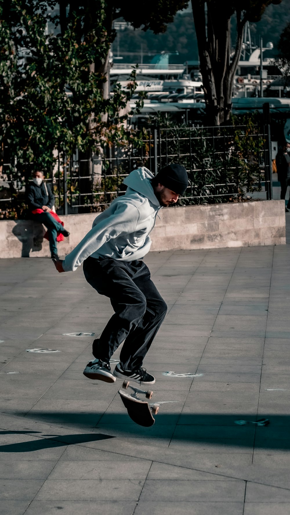 man in white hoodie and black pants playing basketball