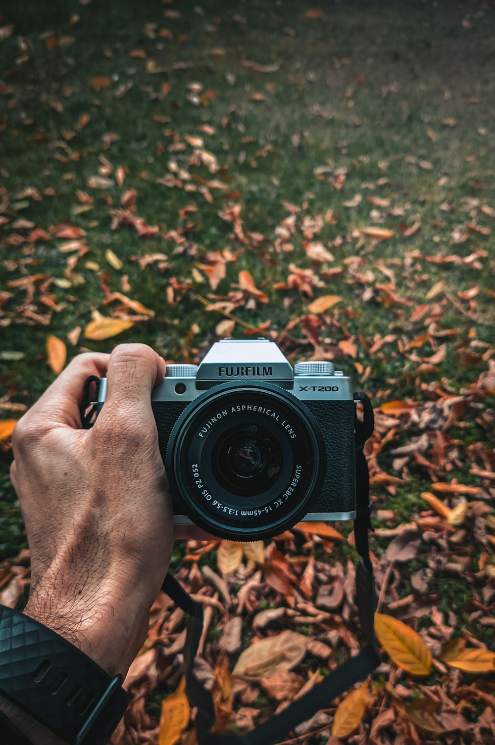 person holding black and white nikon dslr camera