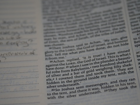 A detailed accounting ledger book open with handwritten notes and calculations.