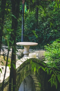 A peaceful outdoor hot stone therapy setup surrounded by greenery.