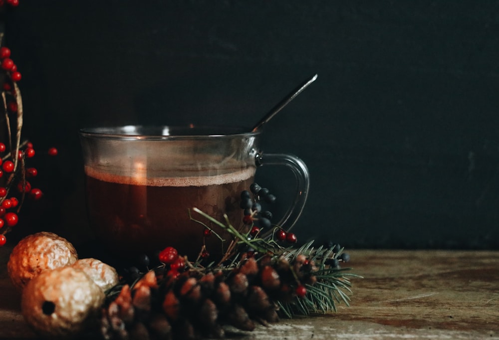 clear glass mug with brown liquid inside