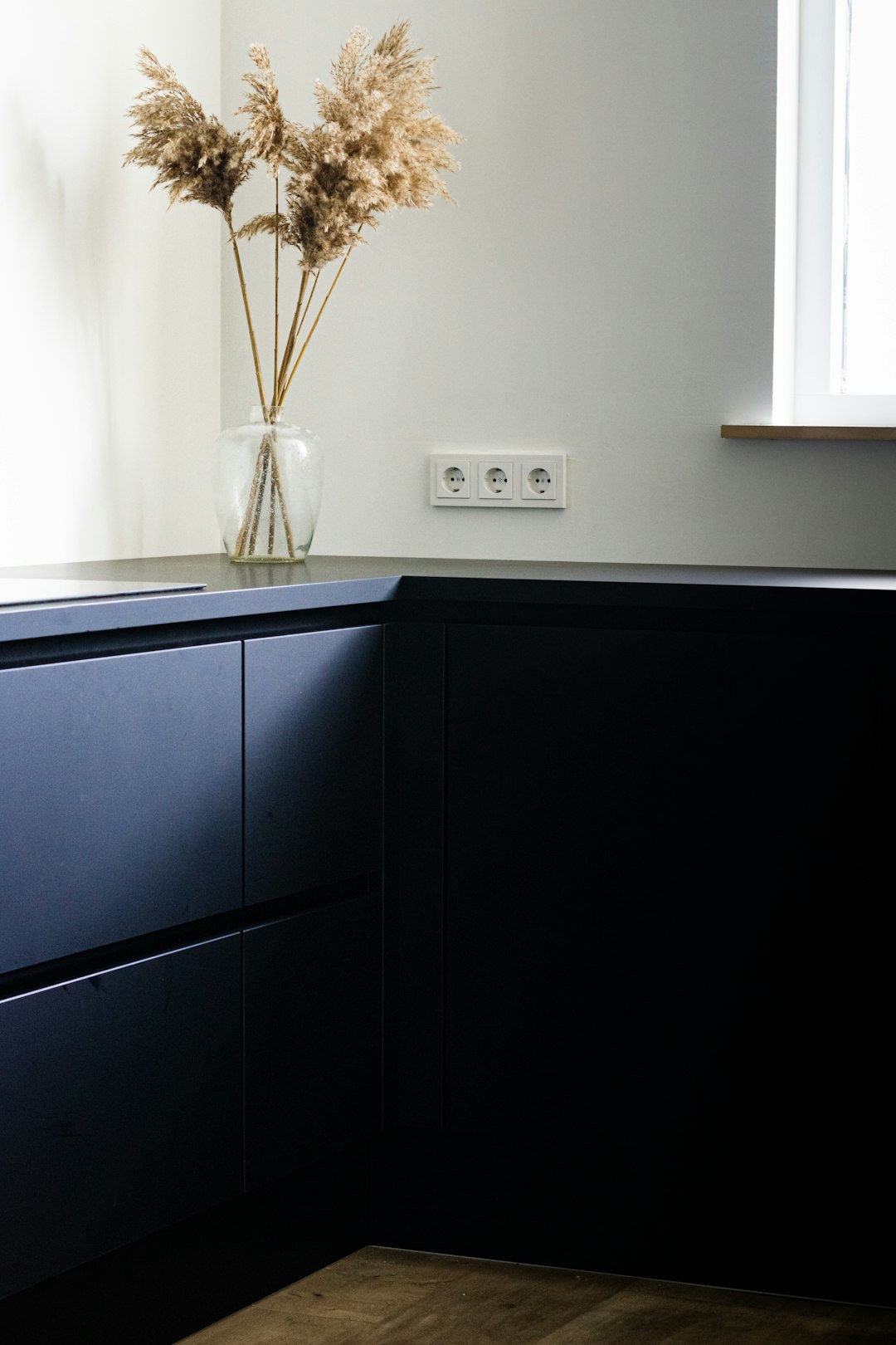 black wooden cabinet near white wall cupboard