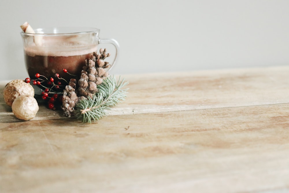 clear glass mug with brown liquid inside