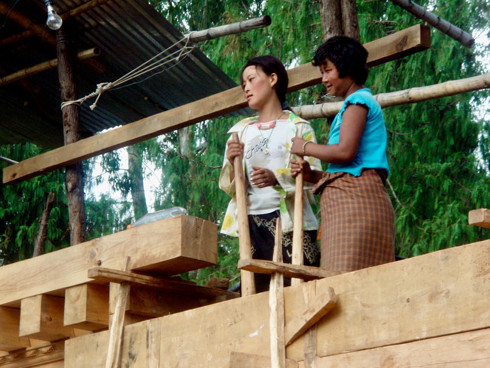 woman in green shirt standing beside woman in white shirt