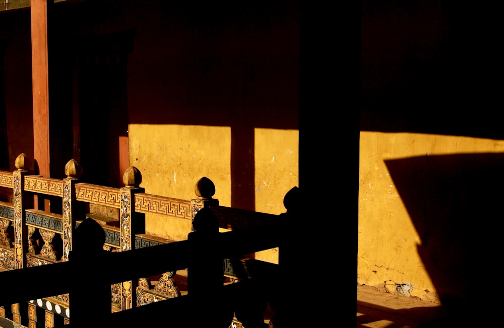 silhouette of man and woman sitting on bench during sunset