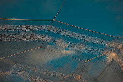 A colorful masonry grid featuring mosquito nets in fresh light blue, highlighting the airy, protective design.