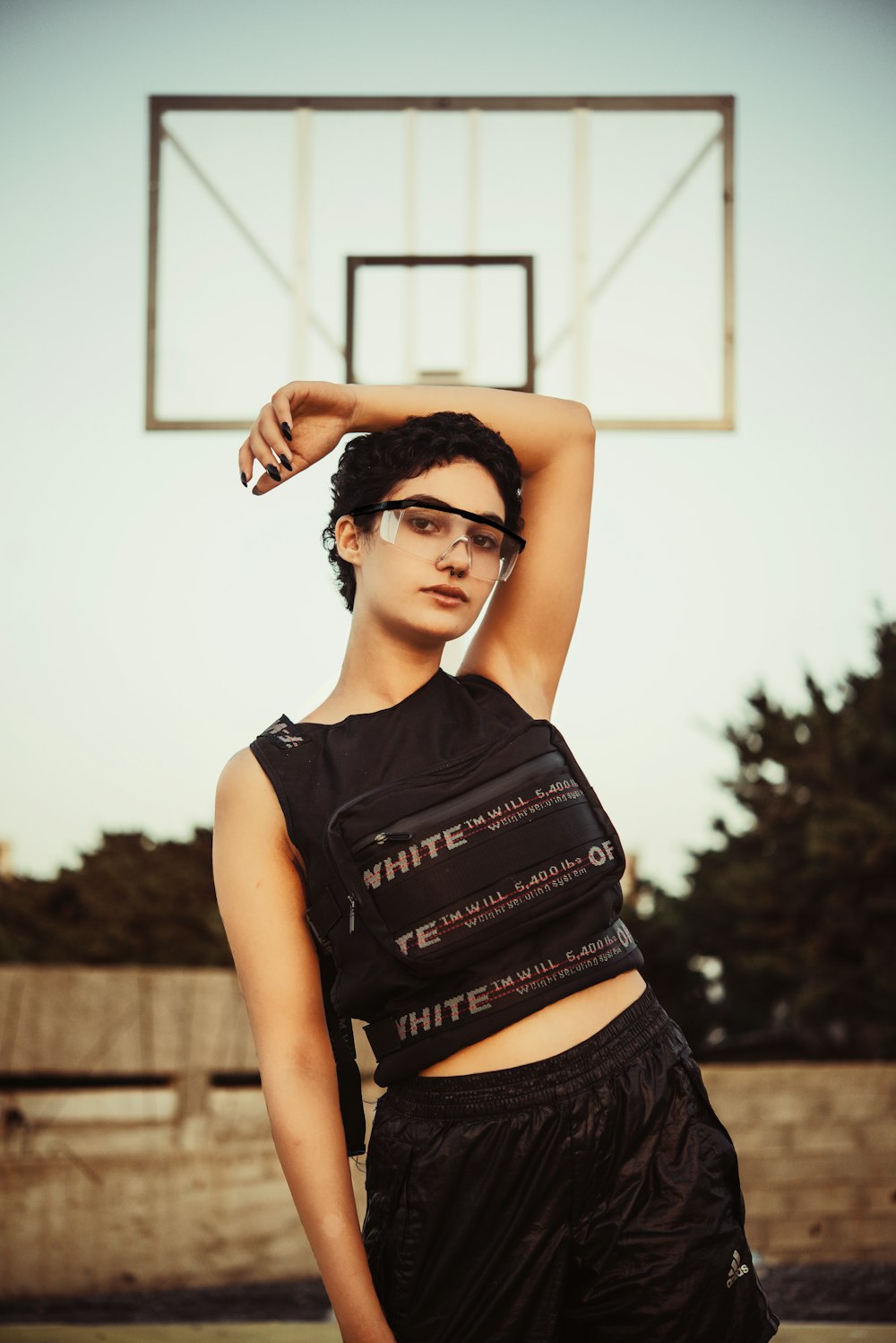 woman in black sleeveless crop top and black denim shorts