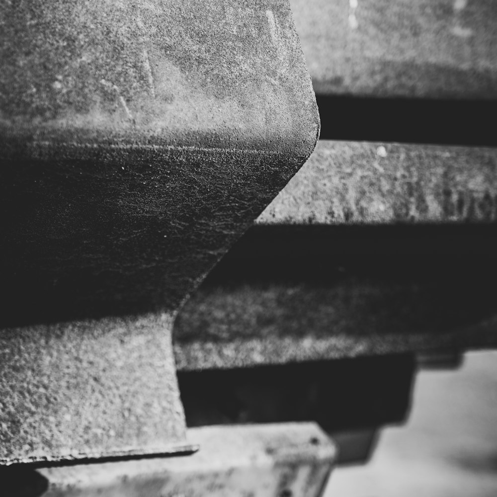 grayscale photo of a concrete bench
