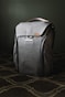 gray leather backpack on brown and white floral textile