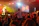 Photo of Mike performing live on stage with vibrant lighting and an enthusiastic crowd.