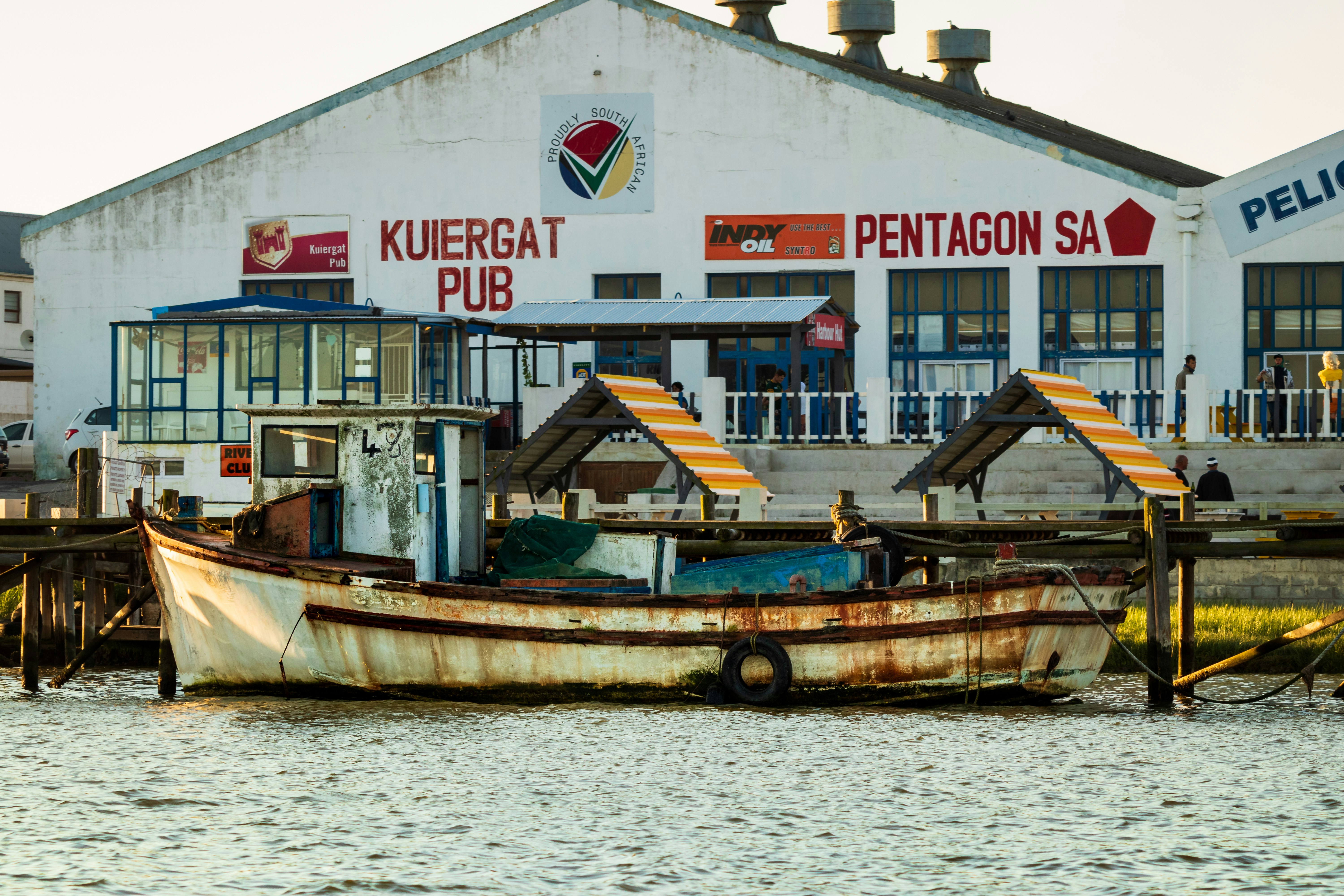 brown and white boat on body of water during daytime
