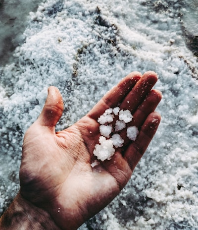 white stones on persons hand