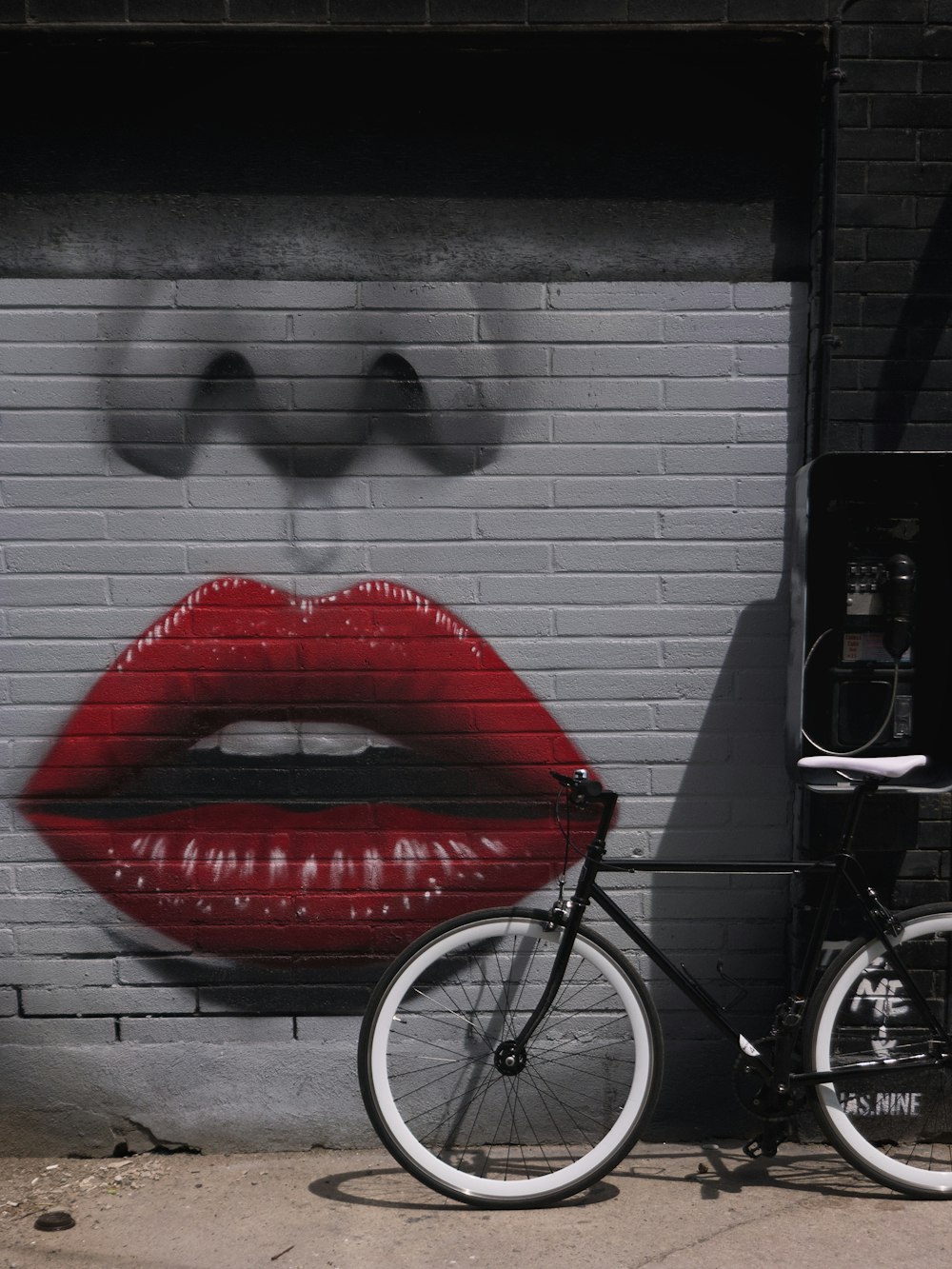 red and black bicycle near white wall