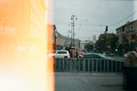 Snapshot of a busy street with traffic and people going about their day.