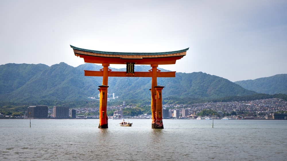 brown wooden arch on body of water during daytime