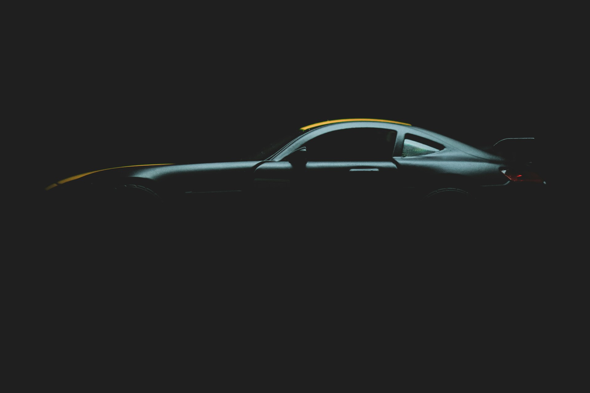 black sports car in dark room
