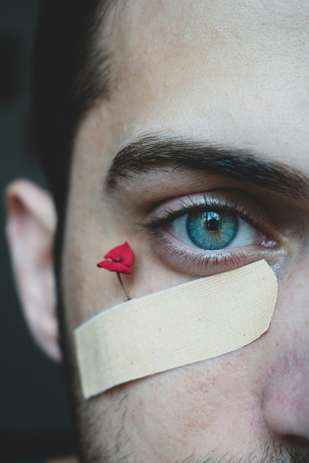 person with red and blue eye shadow