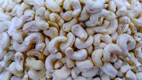 Stacked crates of premium raw cashew nuts ready for export, wrapped in eco-friendly packaging.
