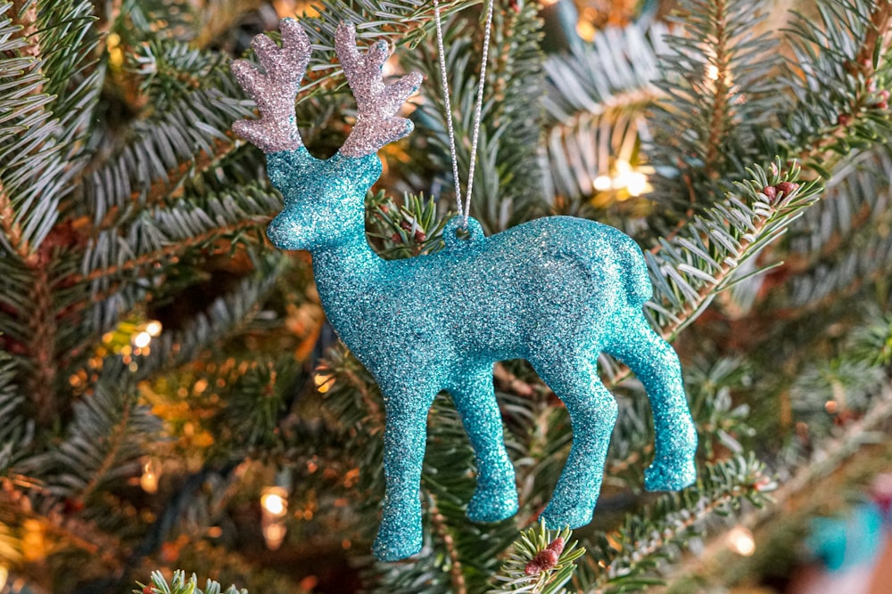 blue dragon figurine on green and brown plant