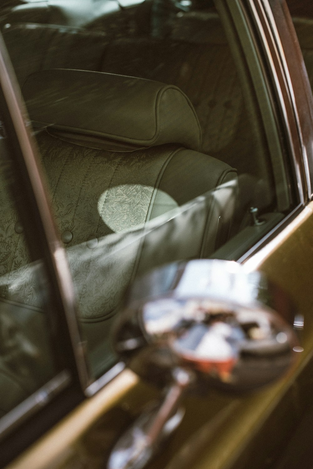 person in gray pants sitting inside car