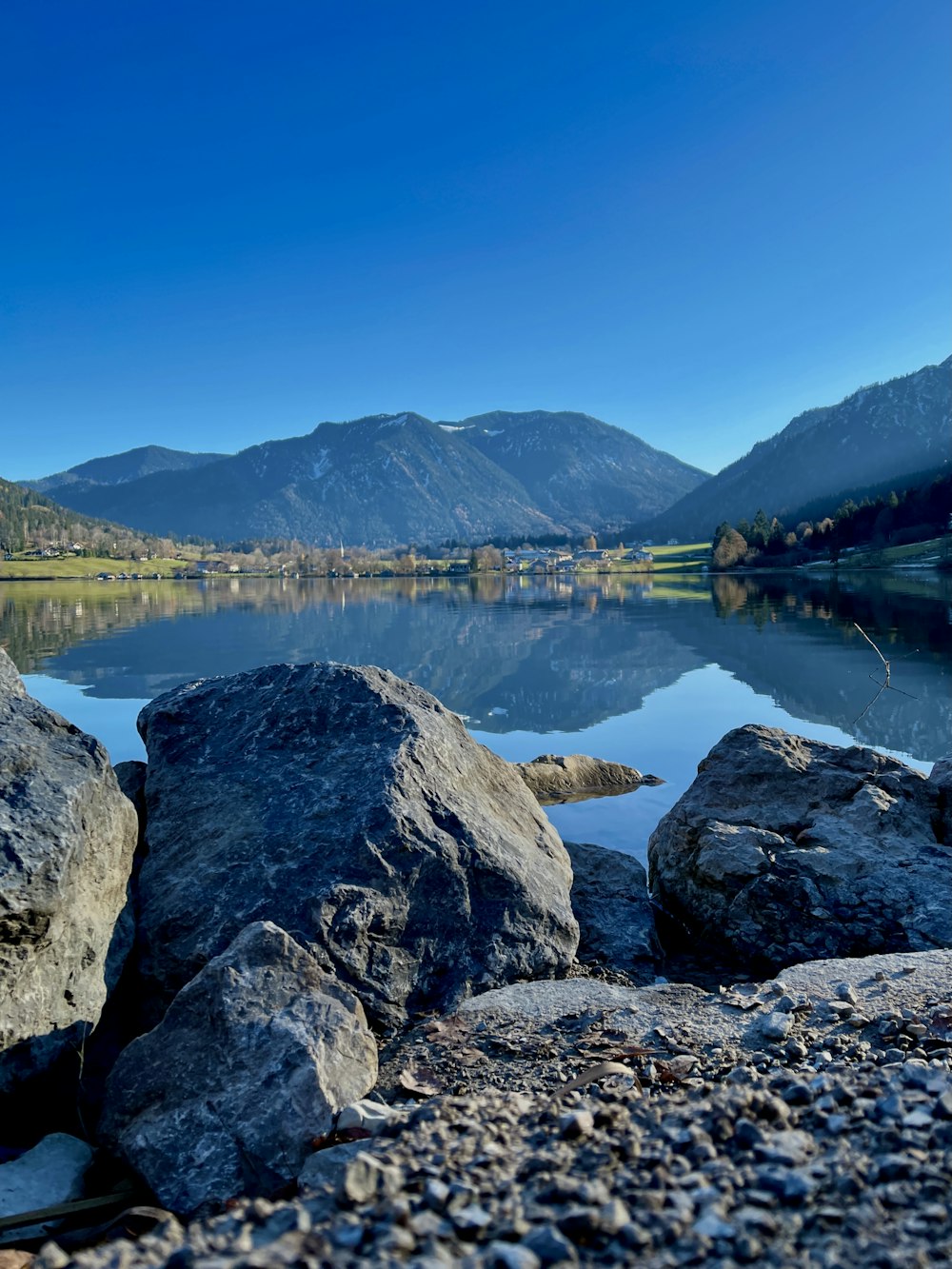 gray and black rock formation near body of water during daytime