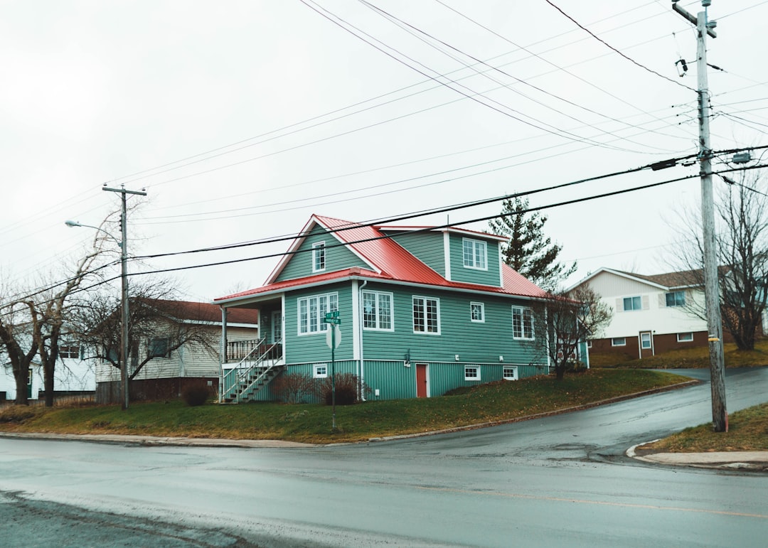 white and brown concrete house beside road during daytime