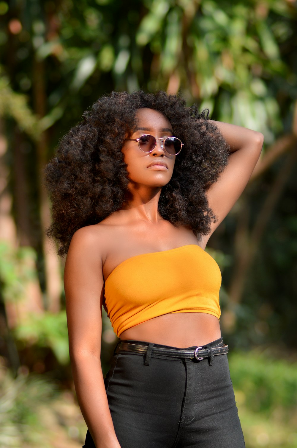 woman in orange tank top wearing black sunglasses