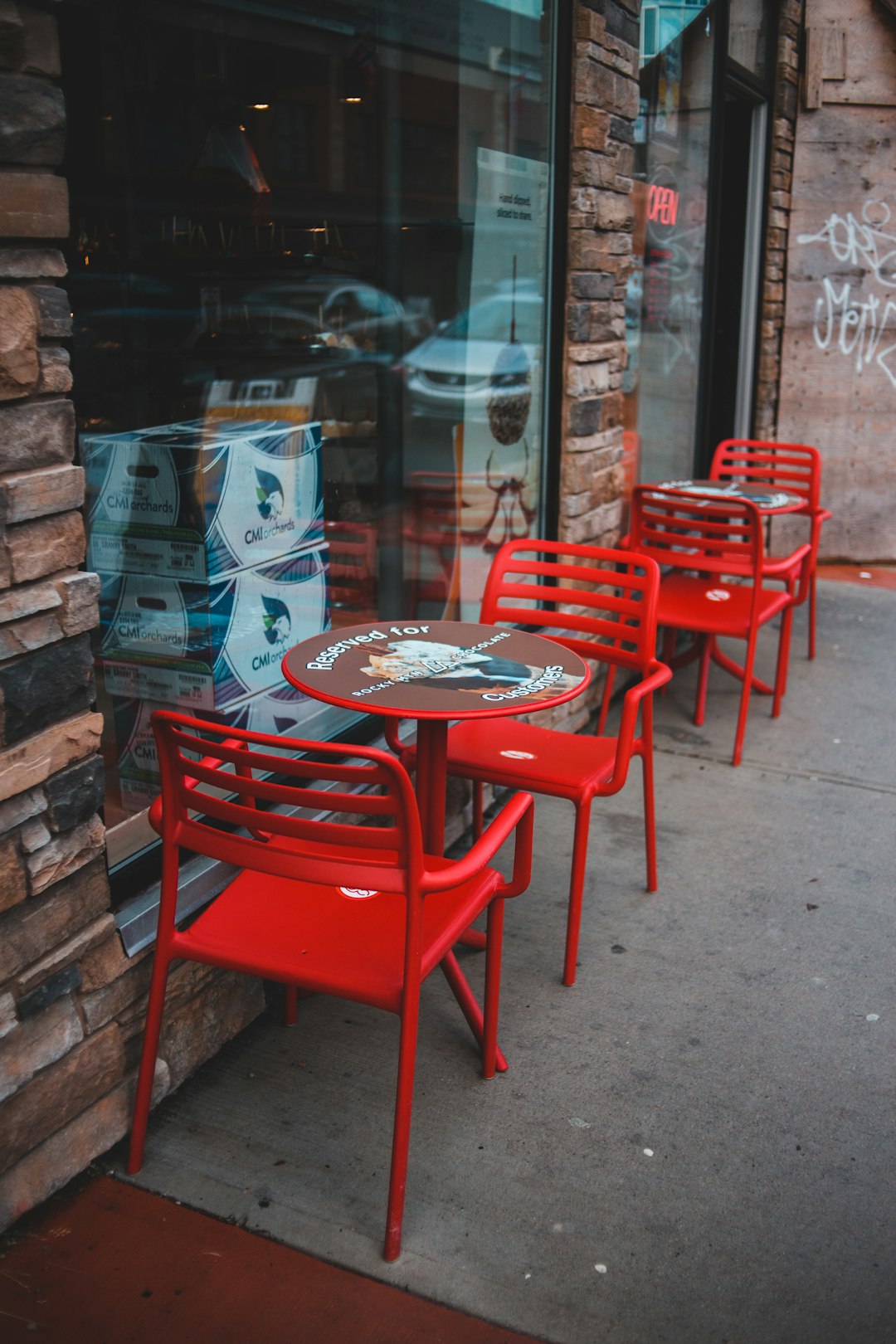 red metal chair beside brown wooden table