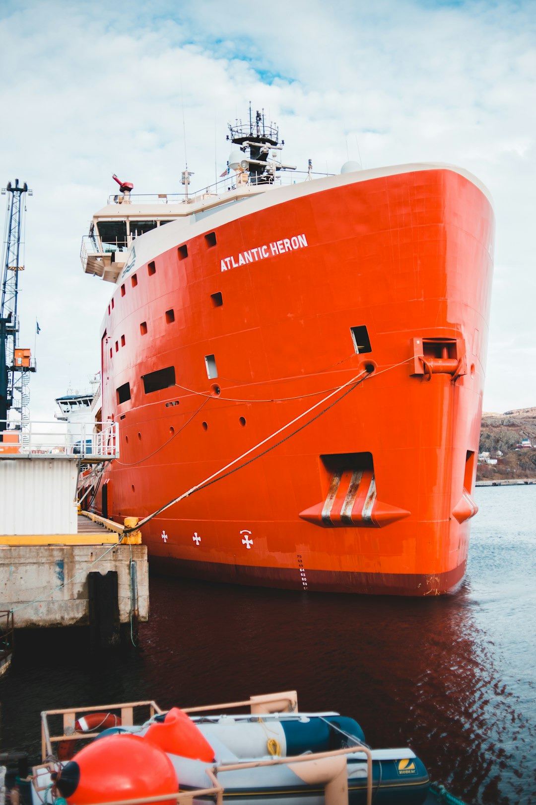 orange and white ship on dock during daytime