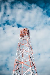 red and white tower under cloudy sky