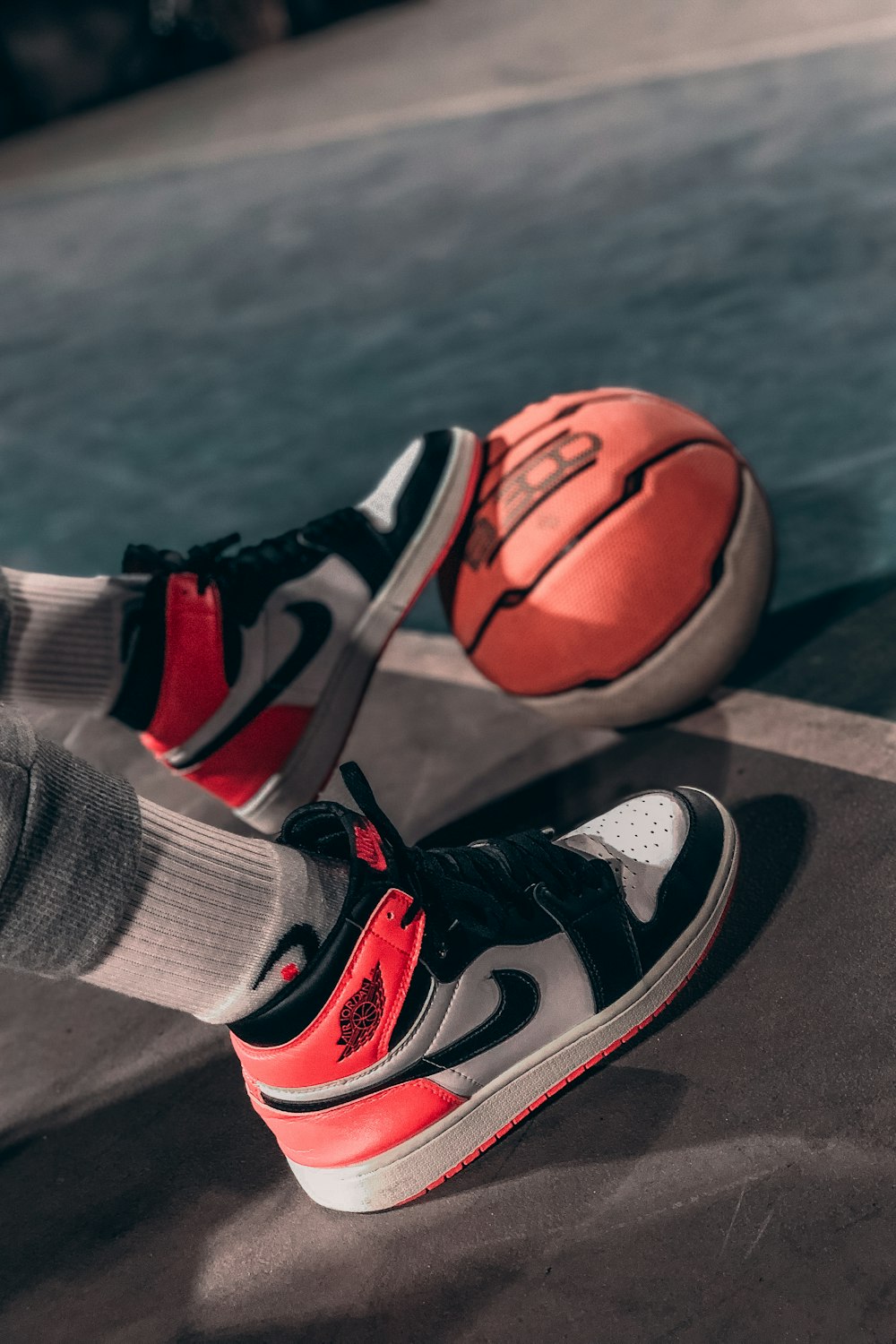 person wearing black and red nike basketball shoes