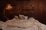 Cozy bed with plush pillows and a warm blanket in the couple’s room.