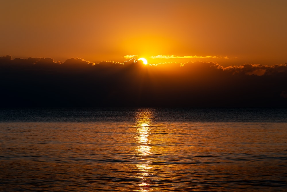 body of water during sunset