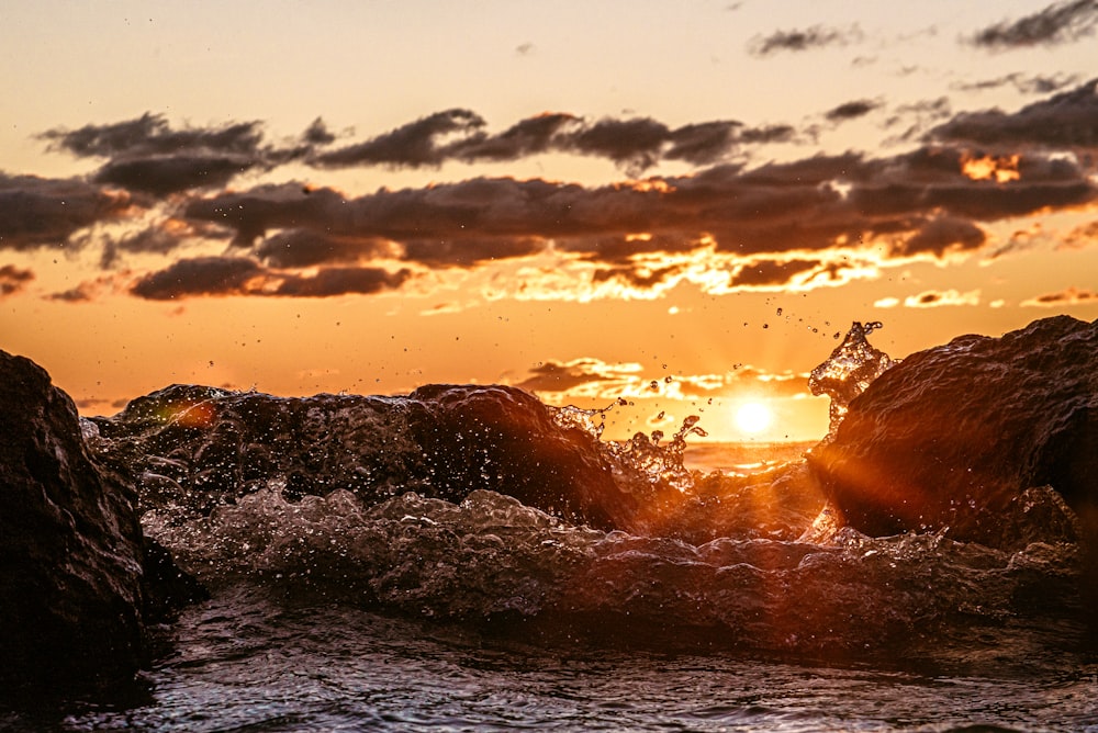 body of water during sunset