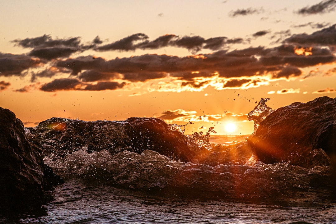 body of water during sunset