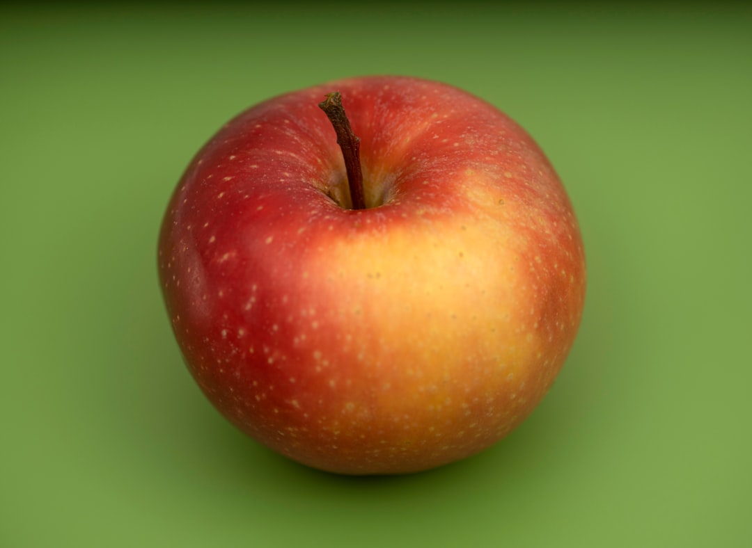 red apple fruit on green surface