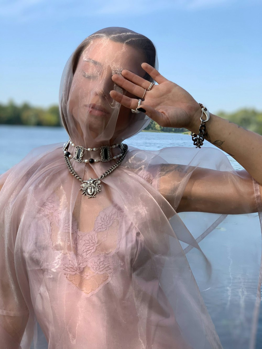 woman in white lace dress wearing silver beaded bracelet