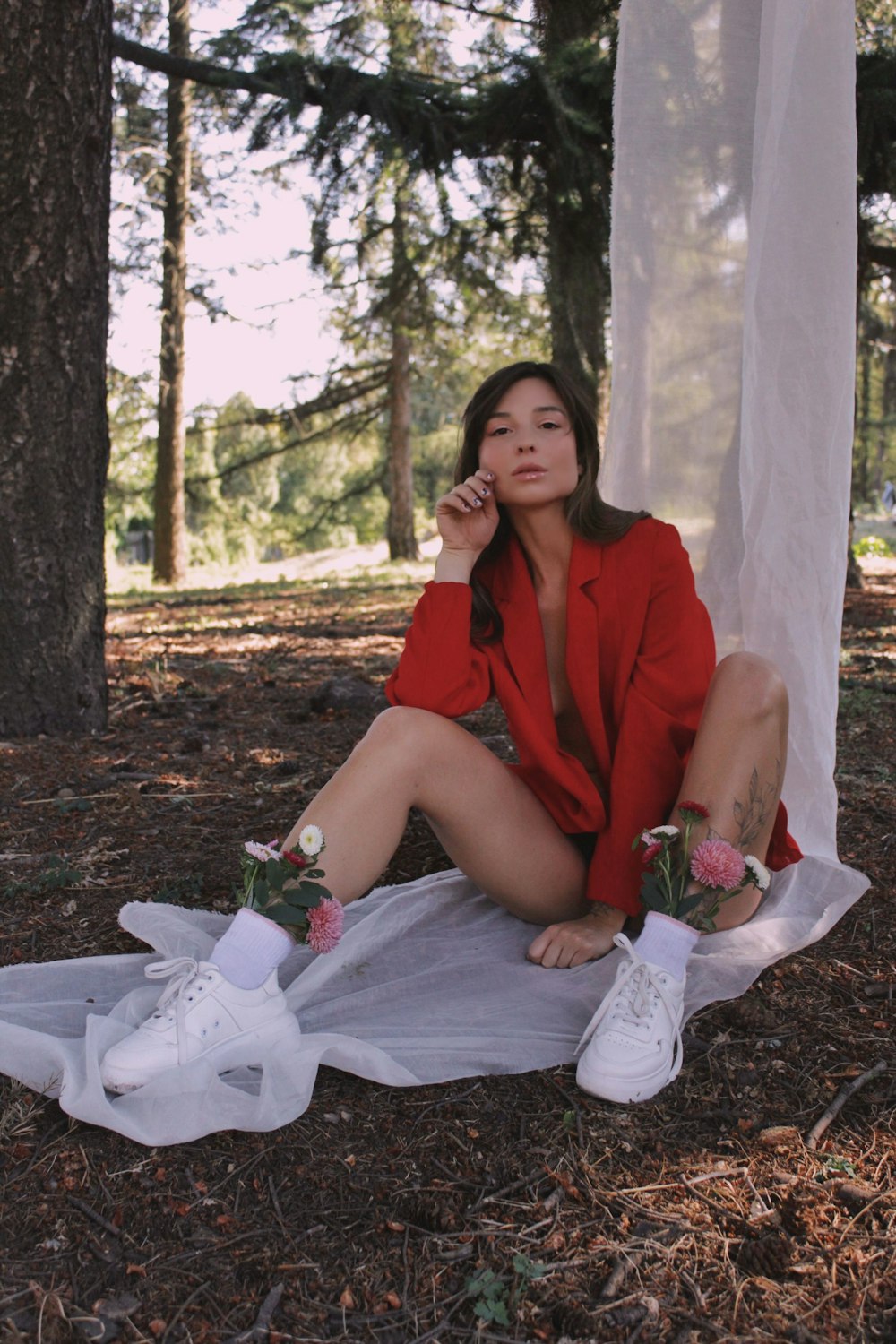 woman in red dress sitting on ground