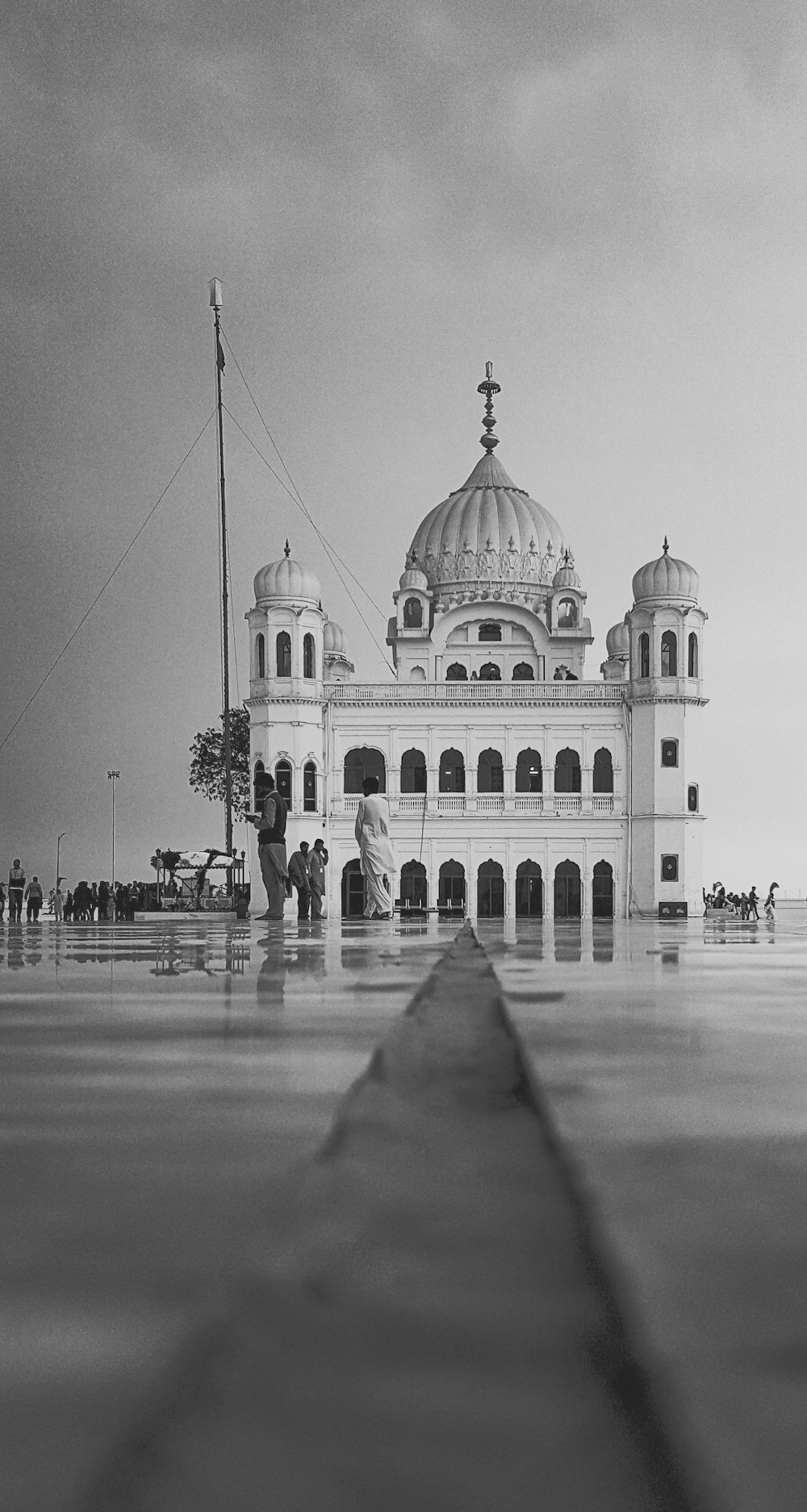 grayscale photo of people walking near dome building