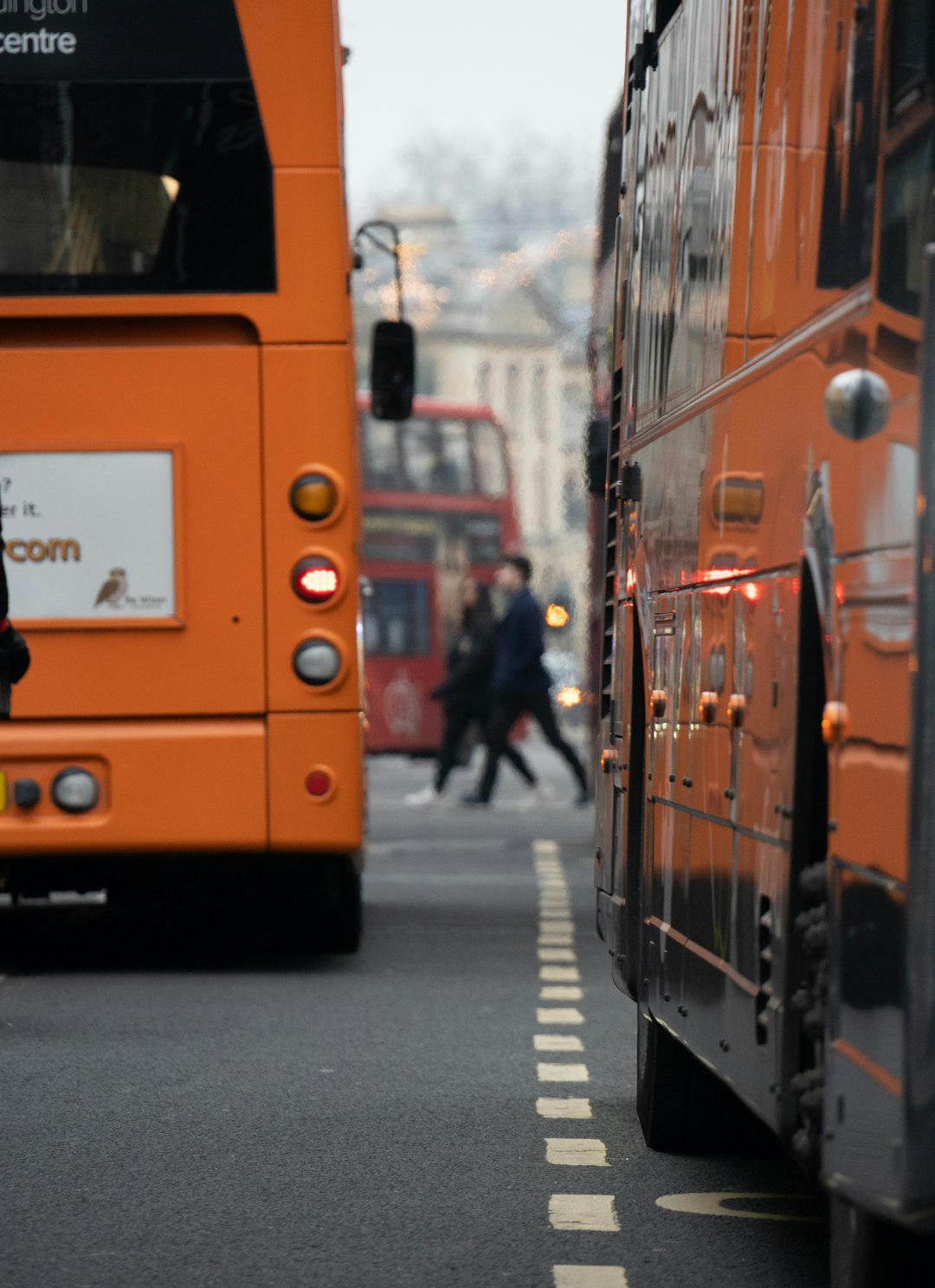 orange bus on the street during daytime