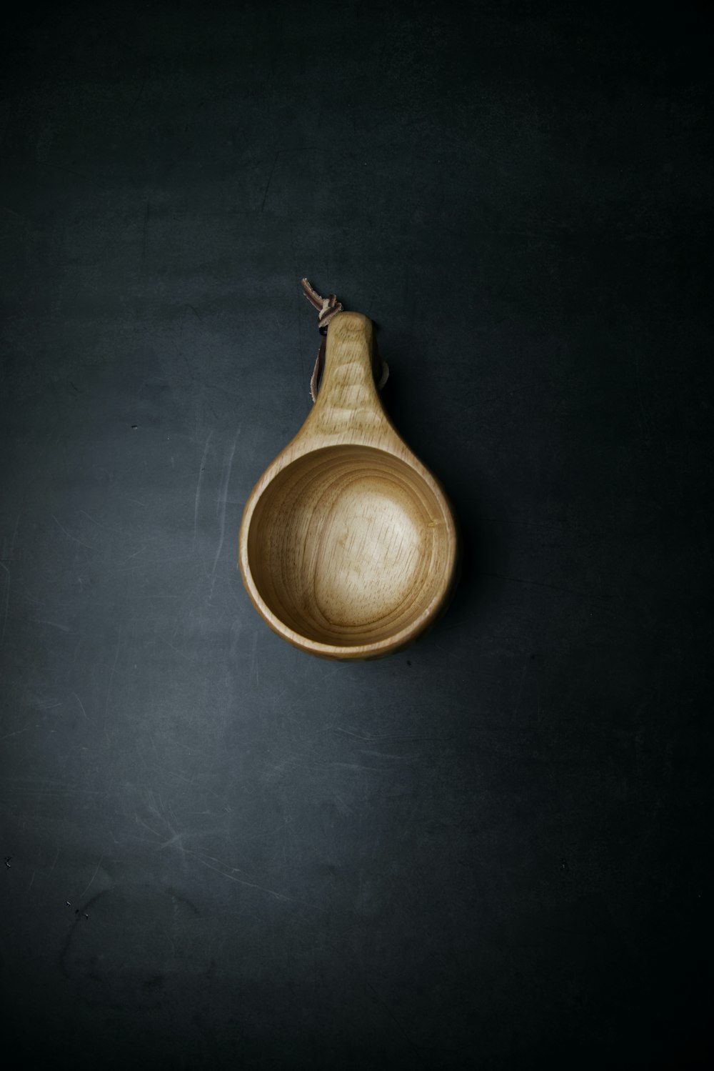 brown wooden bowl on gray surface