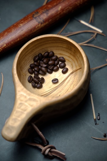 A variety of edible cups displayed on a rustic wooden table with coffee beans scattered around