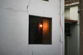 Electrician installing wiring in a residential building with warm lighting.