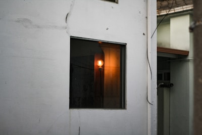 Electrician installing wiring in a residential building with warm lighting.