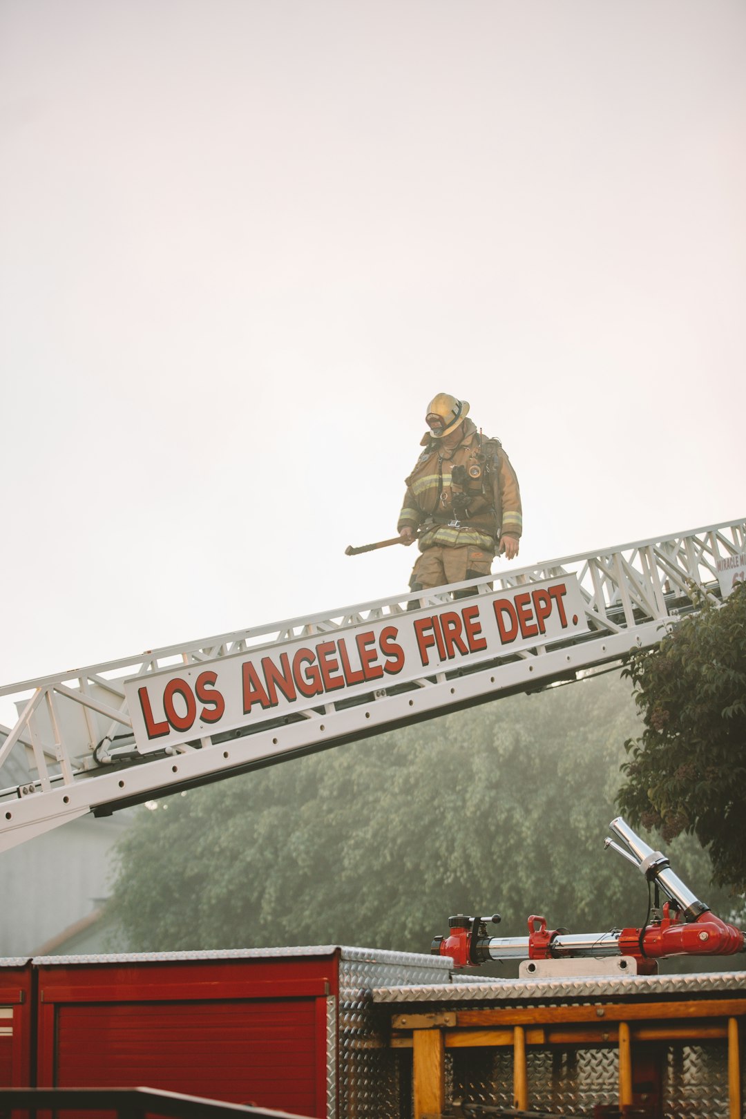 man in brown jacket and pants standing on top of the building