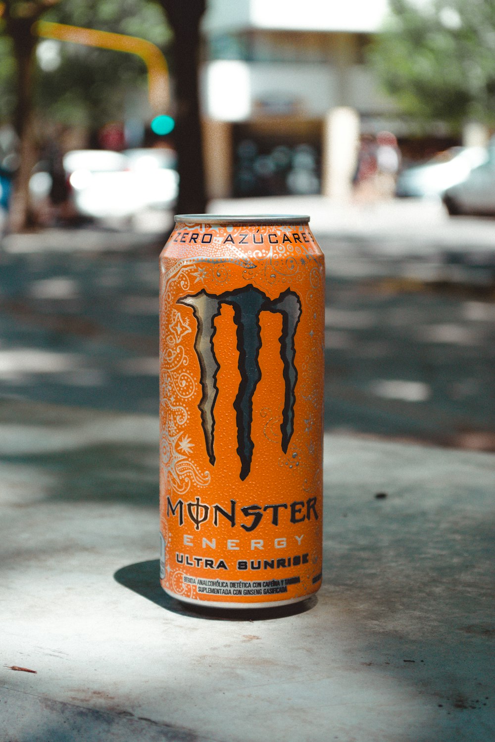 monster energy drink can on gray table